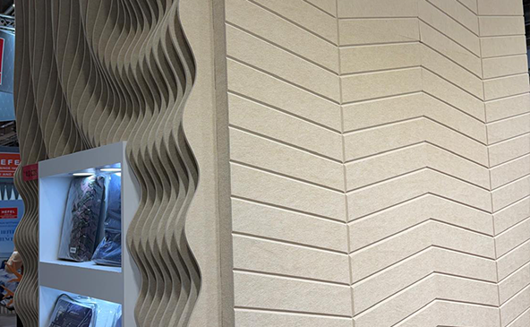 FeltVibe exhibition booth at Heimtextile 2026 showing 3D wave acoustic PET felt panel and V-Cut herringbone cream felt wall panel closeup at Frankfurt trade fair